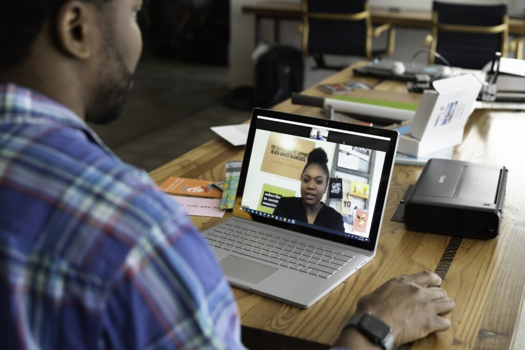 A salesperson working in an office on a virtual call