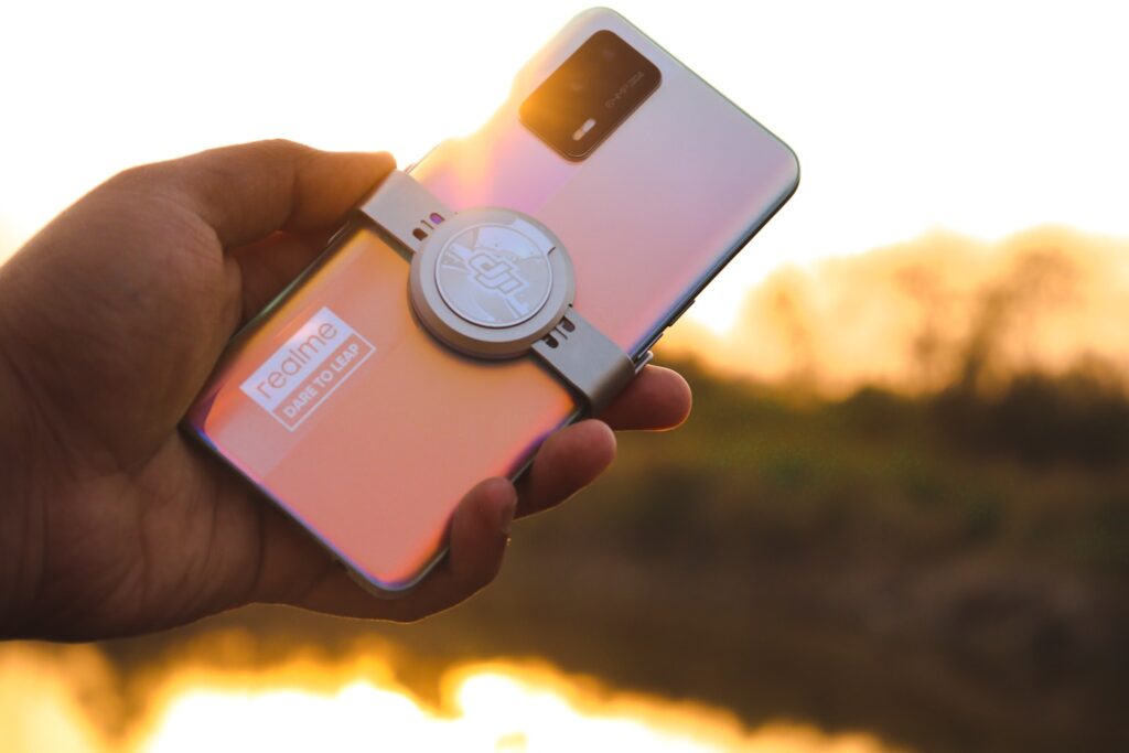a person holding a cell phone in their hand